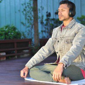 a man sitting on a table wearing headphones